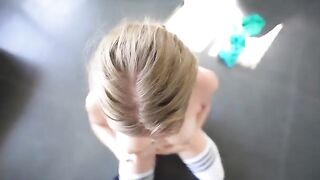 A sweet girl is having fun with her personal trainer in gym