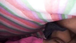 An amateur couple has sex under the sheets, with intense passion