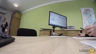 A business lady is trying to get some extra money from a bank in a daring way