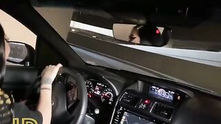 A dirty whore is having fun with a guy in the car in the parking lot