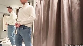 A hot chick is having fun in the fitting room, risking getting caught