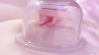 A girl plays with her nipples and clitoris using a sucking toy