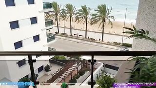 The couple engaged in a passionate session on the balcony while the sea view