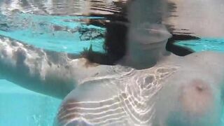 A girl plays with dildo in the swimming pool