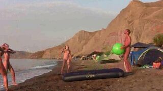 A badminton game with a naughty twist on a naked beach