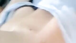 A half-naked girl is lying and caressing her body with her hands