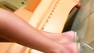 Beautiful woman masturbating on a leather chair, achieving intense pleasure