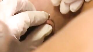 A girl with a clitoris piercing plays with different sex toys