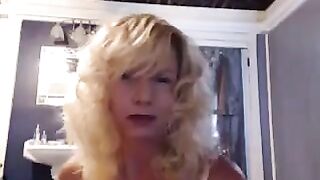 A mature woman has fun in the bathroom with herself