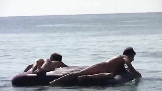 Nude beauties have fun on sunny beach