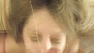 A cumshot on the girl's face after a blowjob performance
