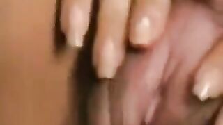 Girl caresses her hairy pussy with a large clitoris