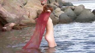 Nudist girl got her small boobs wet in the rain