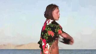 A member shows a girl the wonders of nudity on the beach