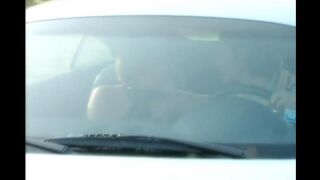 A blonde is having fun on the car’s bonnet