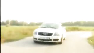 A blonde is having fun on the car’s bonnet