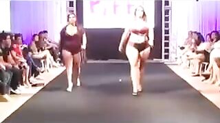 Fatty women in swimsuits are running on the boardwalk in front of the camera