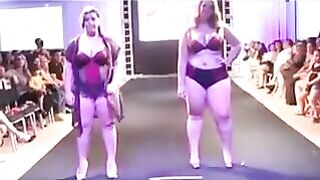 Fatty women in swimsuits are running on the boardwalk in front of the camera