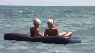 A naked girl is having fun on the beach mattress in HD