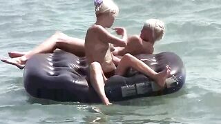 A naked girl is having fun on the beach mattress in HD