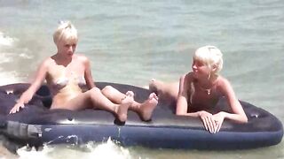 A naked girl is having fun on the beach mattress in HD