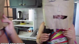 Two girls are having fun with bags on their heads