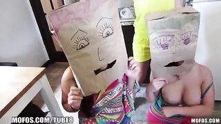 Two girls are having fun with bags on their heads
