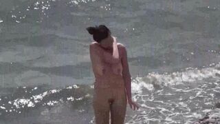 A couple of free-loving people on the beach without clothes