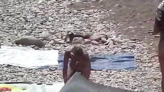 A couple of free-loving people on the beach without clothes