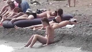 A couple of free-loving people on the beach without clothes
