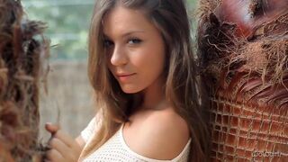 Striptease with a beautiful young Russian woman in an elegant dress