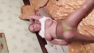 A pregnant woman has a discharge from her breasts in front of the photographer