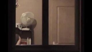 He admires his reflection in the mirror, completely naked
