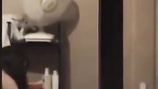 He admires his reflection in the mirror, completely naked