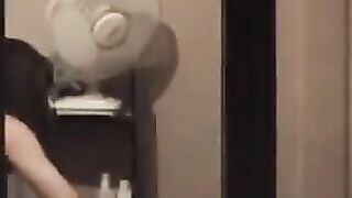 He admires his reflection in the mirror, completely naked