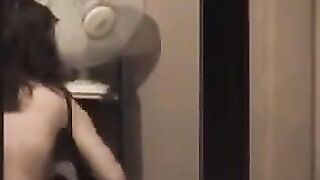 He admires his reflection in the mirror, completely naked