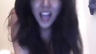 An Asian girl masturbates on her bed, showcasing solo passion
