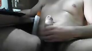 Man sits in front of the computer and masturbates his dick with the help of porn