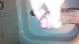 The kid caresses his dick under the shower with his hand until the end