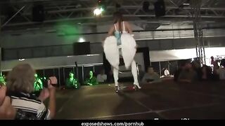 A girl is learning to dance on the strip pole and showing her skills