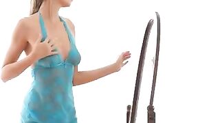 The hot chick is doing erotic moves in front of the mirror