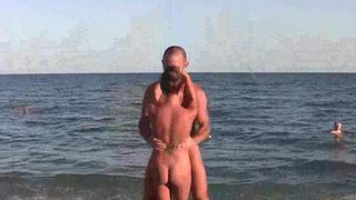 A naked girl is doing acrobatics on the beautiful beach