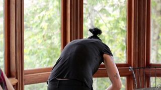 Vietnamese beauty fucked in the kitchen by a passionate brunette with a strap-on