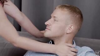 A beautiful woman is giving herself to her man on the couch