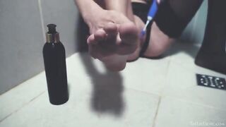 In the shower, a sexy woman plays with sex toys
