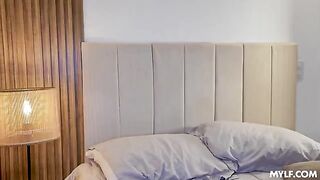 A blonde in a cowgirl pose on the bed, completely uninhibited